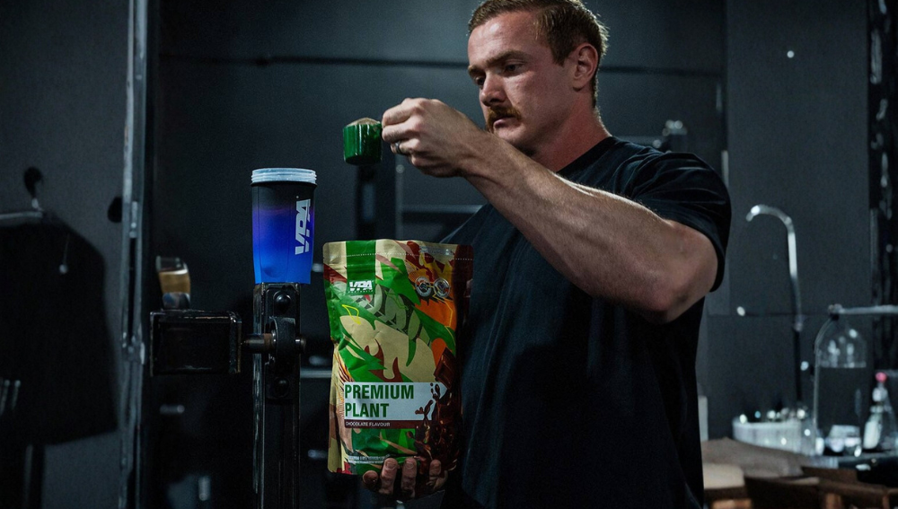 Person opening a colorful container in a dimly lit room.
